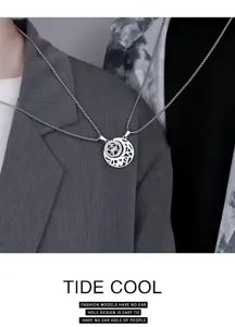 Close-up of the sun and moon hollow couple necklace pendant, showing titanium steel detail.