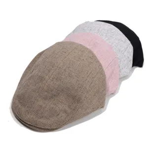 Close-up detail of vintage newsboy caps stacked in multiple colors, classic tweed fabric.