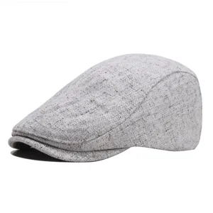 Classic grey tweed flat cap detail shot, showcasing the fine fabric texture and stylish brim shape.
