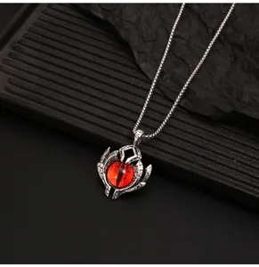 Detailed view of gothic demon eye pendant necklace in titanium steel with red glass eyeball.