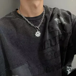 Close-up of titanium steel wavy smiley necklace with OT buckle for hip-hop streetwear.