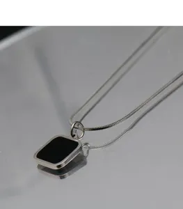 Minimalist titanium steel necklace featuring a sleek black rectangular pendant on a stylish chain.