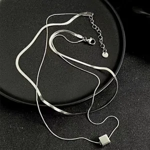 Detailed shot of double-layer titanium steel snake bone chain necklace with a square pendant.