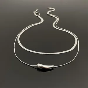 Detailed view of the double layer titanium steel snake chain necklace with smooth pendant.