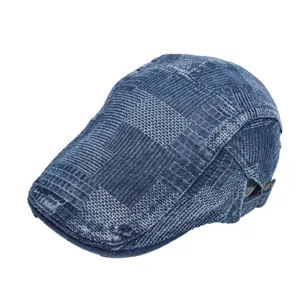 Close-up view of vintage denim flat cap, showing unique fabric texture and metal buckle detail.