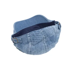 Detailed view of vintage denim patchwork newsboy cap with adjustable metal buckle back design.