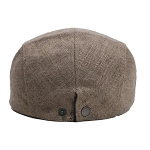 Back detail view of the brown tweed newsboy cap showing fabric and adjustable snap.