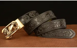Detail of men leather automatic belt with gold dragon buckle and embossed classic pattern.