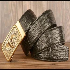 Detailed view of mens automatic buckle leather belt with crocodile pattern and golden elephant design.