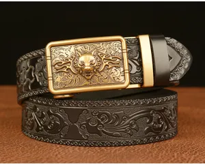 Men's leather belt detail view featuring golden wolf head buckle and embossed pattern.