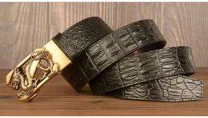 Detailed view of men's black crocodile pattern leather belt with golden dragon buckle.