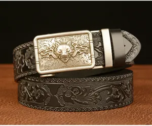Detailed view of men's automatic buckle leather belt with wolf head and carved floral pattern.