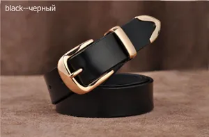 Details of women's black leather belt with metal buckle, classic British style accessory.