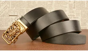 Men's leather belt detail shot featuring a unique golden scorpion automatic buckle and cowhide strap.