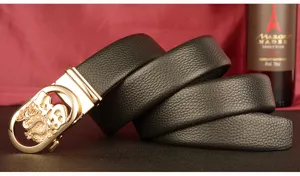 Close-up detail shot of men's black leather belt with gold dragon buckle and texture.