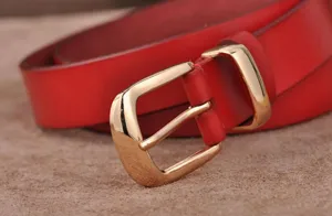 Red leather belt for women with elegant polished gold-tone pin buckle for casual jeans wear.