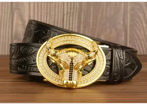 Detailed view of luxury rhinestone bull head buckle men leather belt with embossed strap.