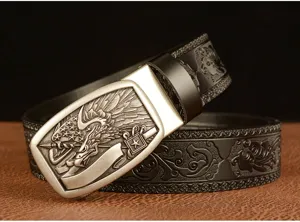 Close-up of embossed leather belt with metal automatic buckle and intricate floral patterns.