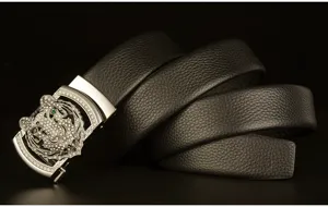 Detailed view of black cowhide leather belt featuring sparkling rhinestone tiger head automatic buckle.