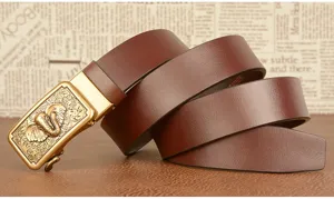 Detailed view of brown men's leather belt with golden automatic elephant relief buckle.