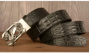 Detailed view of men black crocodile pattern leather belt with vintage dragon buckle