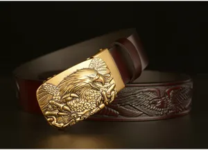 Detail shot of men's retro carved cowhide leather belt with fierce eagle automatic buckle