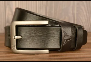 Detailed shot of a black genuine leather belt with a sleek silver pin buckle and embossed bull logo.