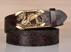 Detail view of vintage mens leather belt featuring embossed dragon pattern and metal buckle.