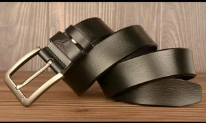 Detail shot of black genuine leather casual belt with metal pin buckle and bull head embossing.