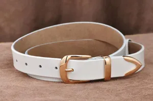 White leather women belt with golden metal buckle and tip decor, stylish jeans accessory.