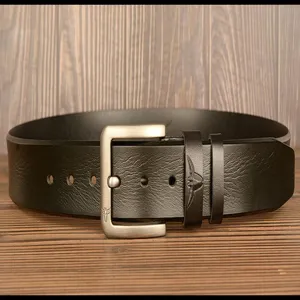 Close-up detail of genuine leather casual belt with metal pin buckle and bull head embossed loop.