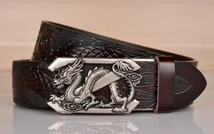 Detailed view of men's leather belt with metallic dragon embossed buckle and vintage pattern.