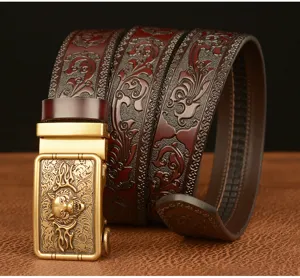 Detailed shot of men's leather belt with wolf head buckle and embossed Tang grass design.