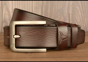 Close-up detail of men genuine leather belt with metallic pin buckle and bull logo decoration.
