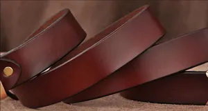 Close-up detail of the brown leather women belt showing fine texture and smooth finish.