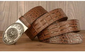 Close-up detail of vintage crocodile pattern leather men belt with ornate dragon buckle.