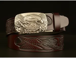 Close-up detail of vintage leather belt with metallic eagle buckle and embossed strap.