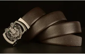 Detailed shot of men's genuine leather belt featuring a sparkling rhinestone tiger buckle.