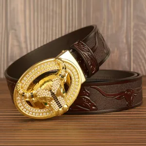 Luxury men leather belt with dazzling rhinestone gold bull buckle and embossed strap for stylish wear.