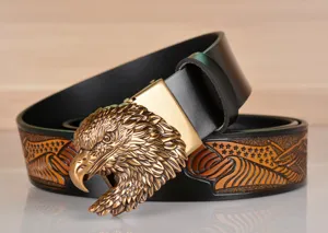 Close-up view of vintage leather men belt with detailed bronze eagle head buckle and embossing.