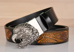 Detailed shot of mens leather belt featuring metallic eagle buckle and vintage embossed strap.