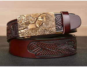 Detail shot of men's genuine leather belt featuring an embossed eagle metal automatic buckle.