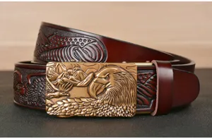 Close-up detail of embossed eagle buckle on brown leather men belt texture display.