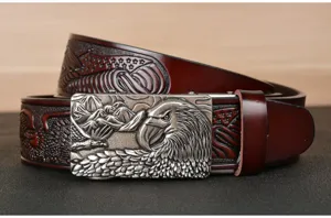 Close up detail of men leather belt with embossed eagle buckle and detailed carving patterns.