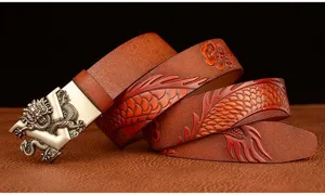 Detailed view of the embossed dragon pattern and metal automatic buckle on the brown leather belt.