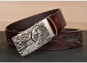 Detailed shot of mens leather automatic buckle belt with vintage eagle relief embossing.