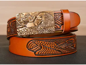 Close-up detail of embossed leather belt featuring vintage eagle buckle and pattern.