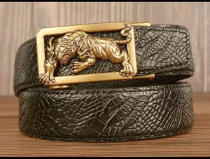 Close-up detail of men's leather belt with 3D tiger brass automatic buckle and crocodile pattern.