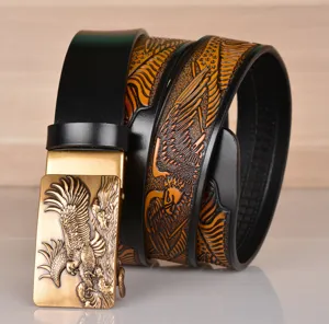 Detailed shot of mens leather belt featuring embossed eagle pattern and gold automatic buckle.