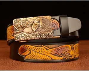 Men's leather belt detail showcasing embossed eagle metal buckle and carved strap pattern.